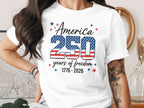 White t-shirt with "America 250 years of freedom 1776-2026" text.