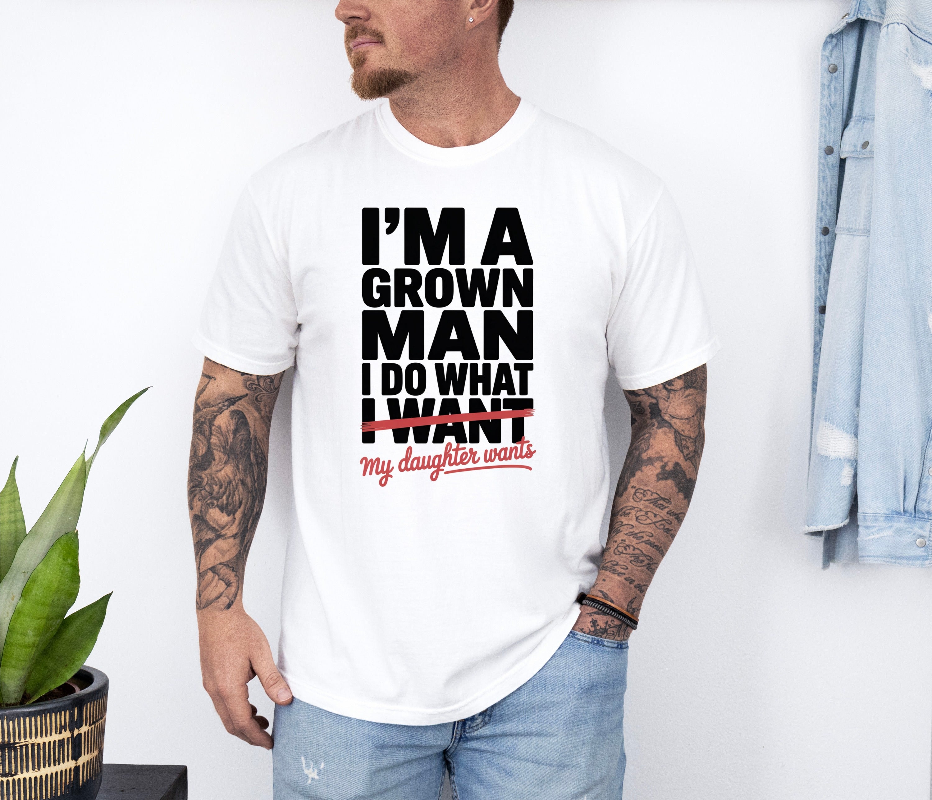 White t-shirt with black text: "I'm a grown man, I do what I want, my daughter wants".